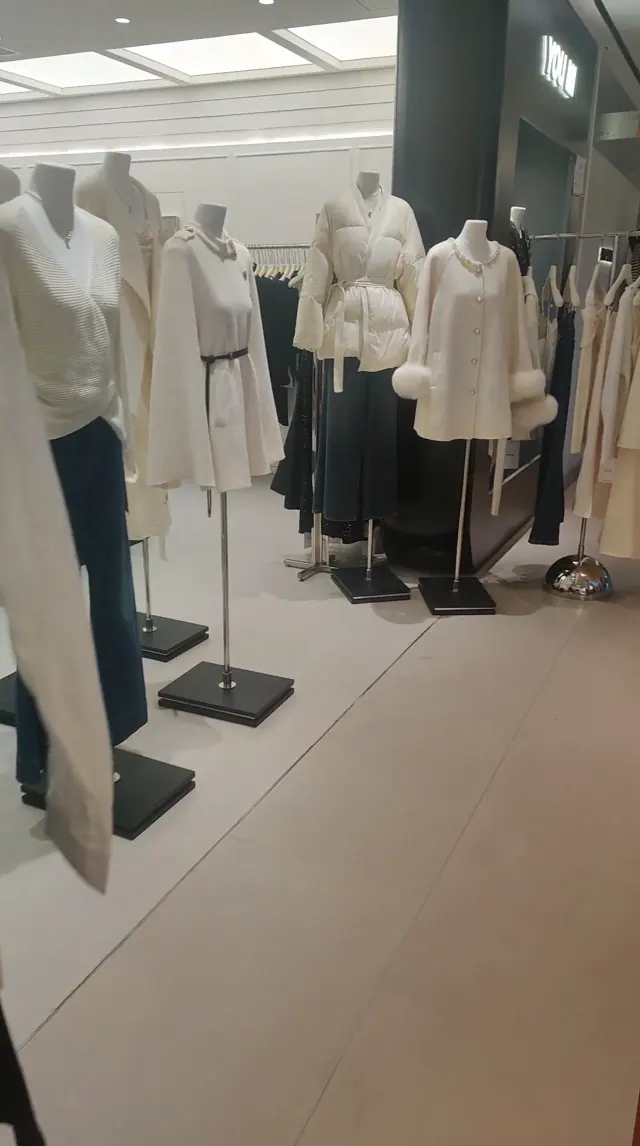 Garments displayed on mannequins in a showroom, in archival footage from 2024.